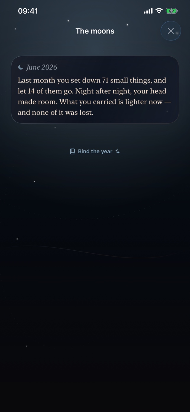 The moons screen showing a calm monthly reflection and an option to bind the year.
